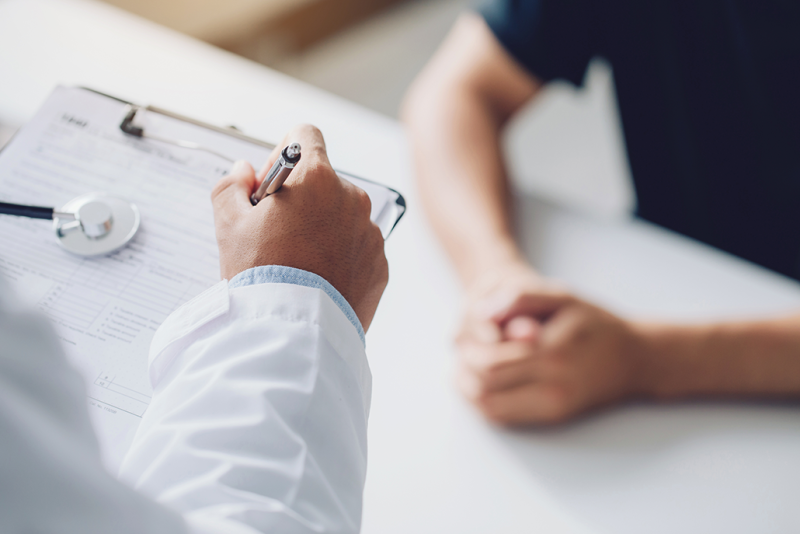 Doctor asking the patient questions and taking notes