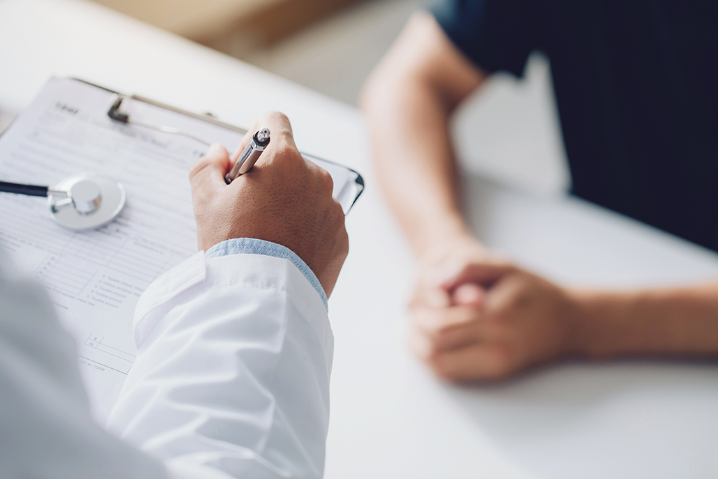 Doctor asking the patient questions and taking notes